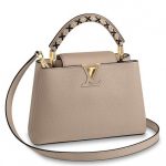 Knockoff Louis Vuitton fake LV Capucines BB Bag With XOXO Motif Handle M52384 BLV814. This edition of the Capucines handbag presents a playful message delivered through exacting workmanship. The top handle features an XOXO motif