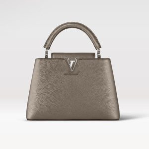 Knockoff Louis Vuitton fake LV Capucines BB LV Bag Etain Metallic Gray M21102. This Capucines BB handbag is crafted from Taurillon leather treated with metallic pigments to give the bag an iridescent aspect. In addition to the top handle