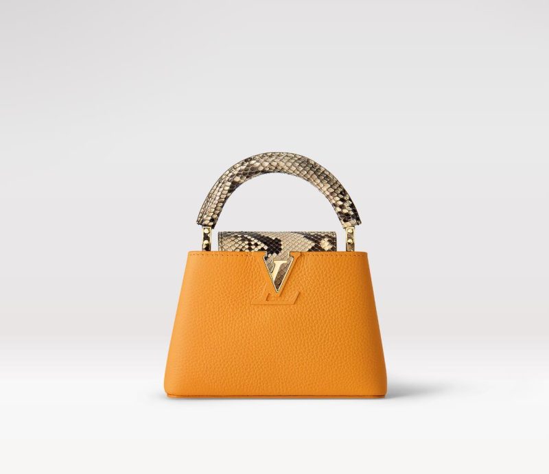 Fake Louis Vuitton Capucines Mini LV Bag Golden Yellow N81410. This exotic piece cannot be shipped to CaliFornia. The vibrant golden-yellow Taurillon leather blends beautifully with the natural python leather on the flap and handle of this eye-catching Capucines Mini handbag. Carried by hand